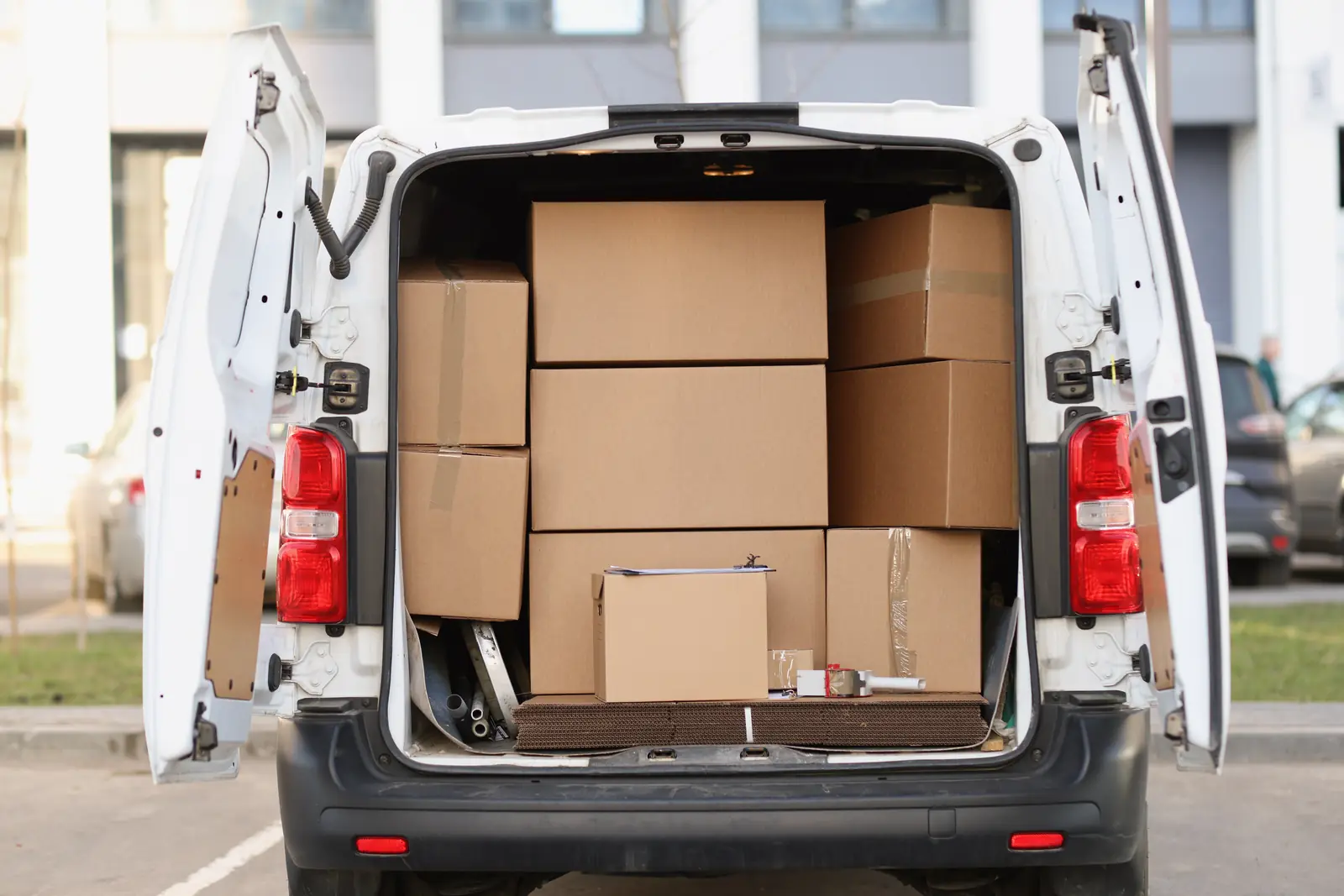 Rear of a cargo van filled with boxes, shown as commercial operations photography rather than merchandise for sale.
